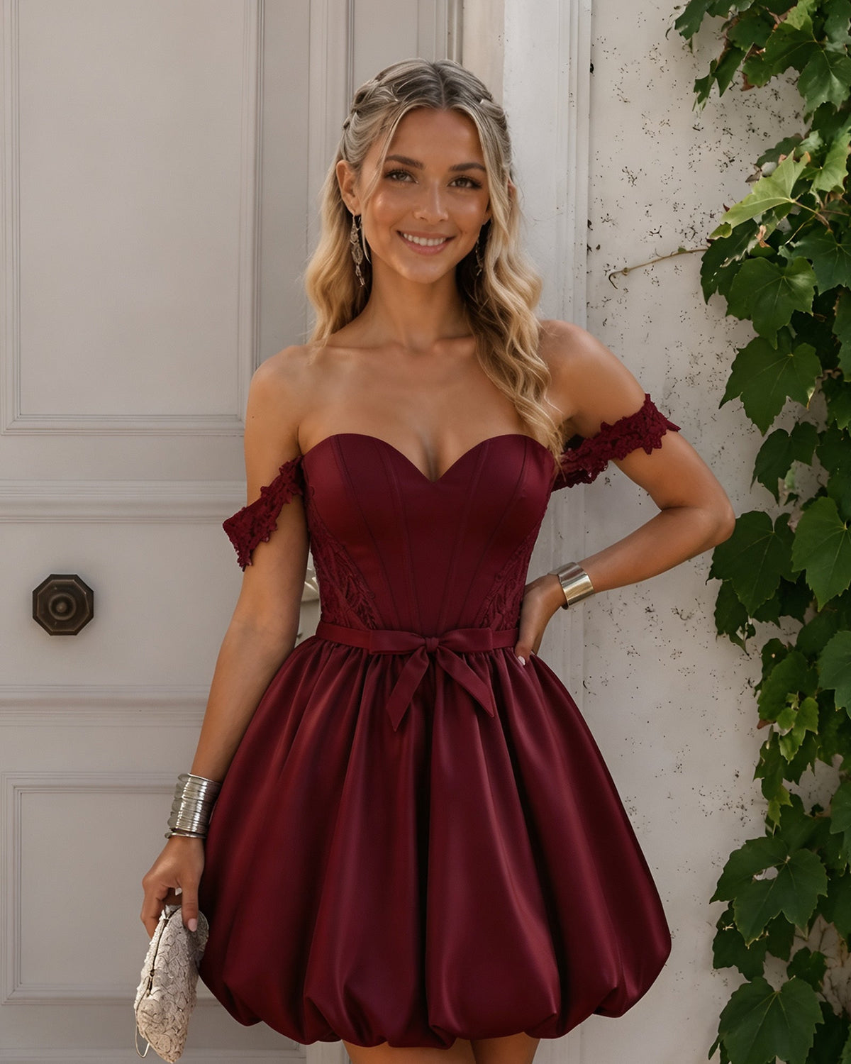 Off-shoulder satin homecoming dress in burgundy with lace-trimmed sleeves and bubble skirt