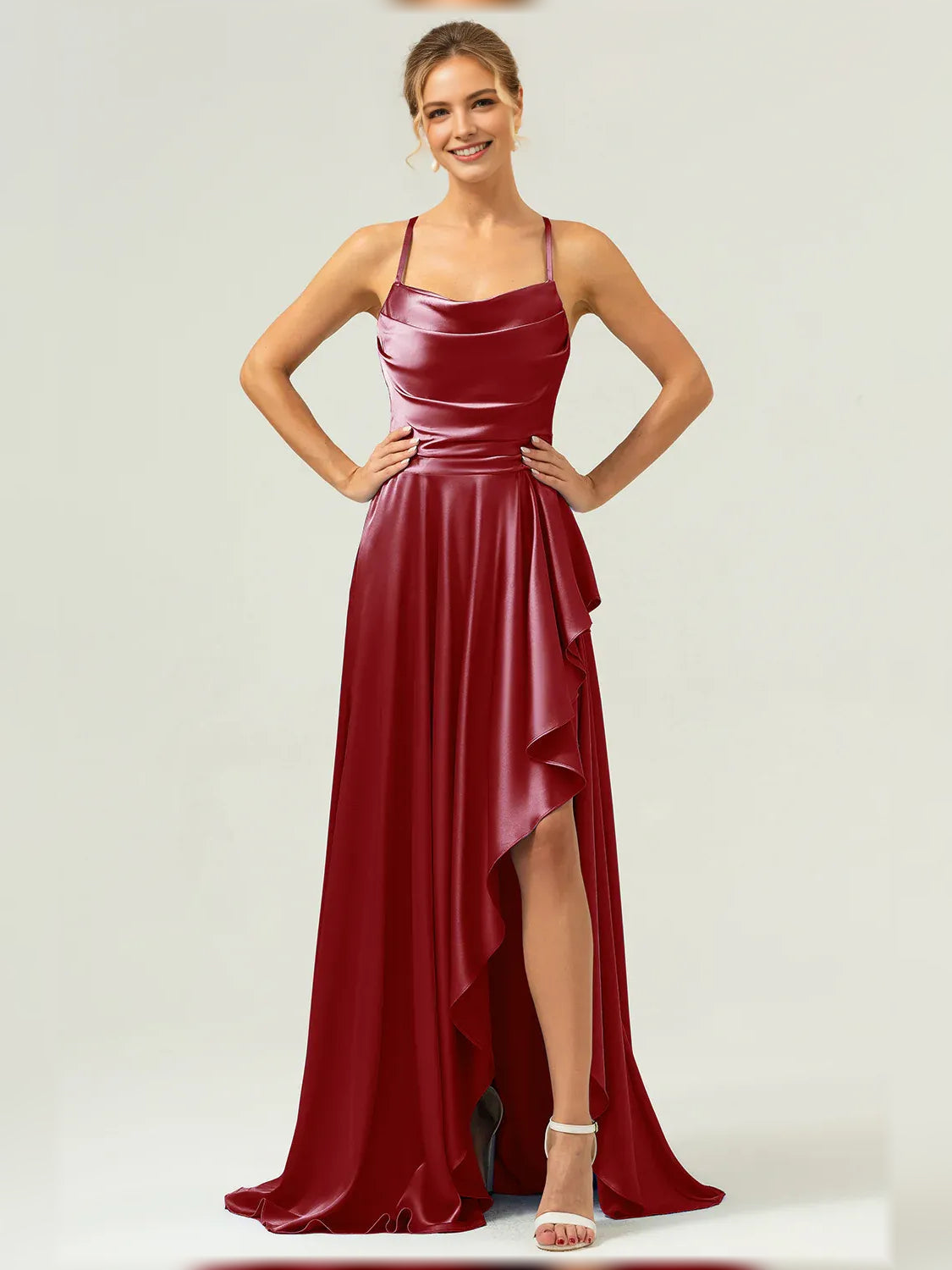 Burgundy formal satin maxi dress with cowl neckline, spaghetti straps, and asym ruffle slit