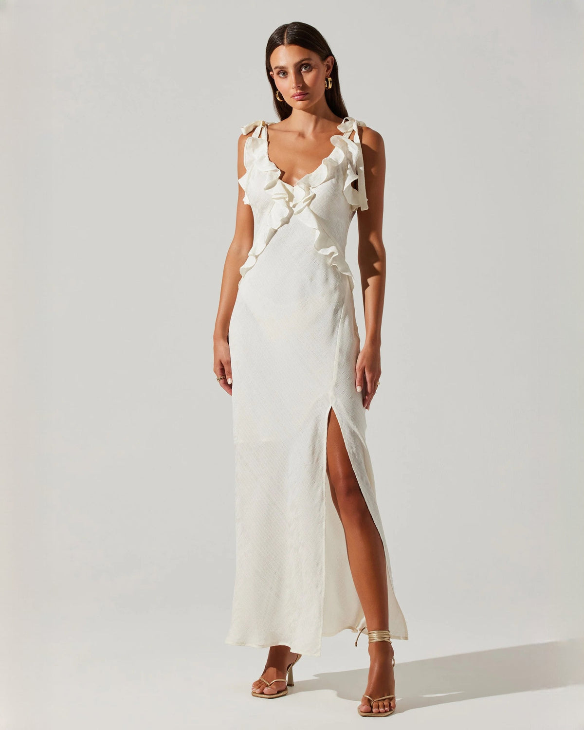 White satin maxi dress with sleeveless ruffle V-neck and front slit
