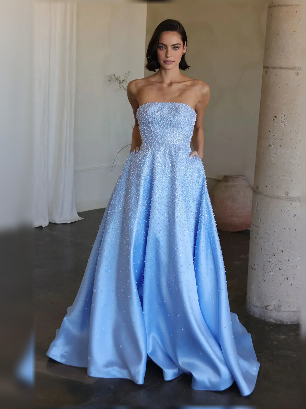 Light blue strapless beaded corset formal dress with sparkly bodice and flowing skirt.