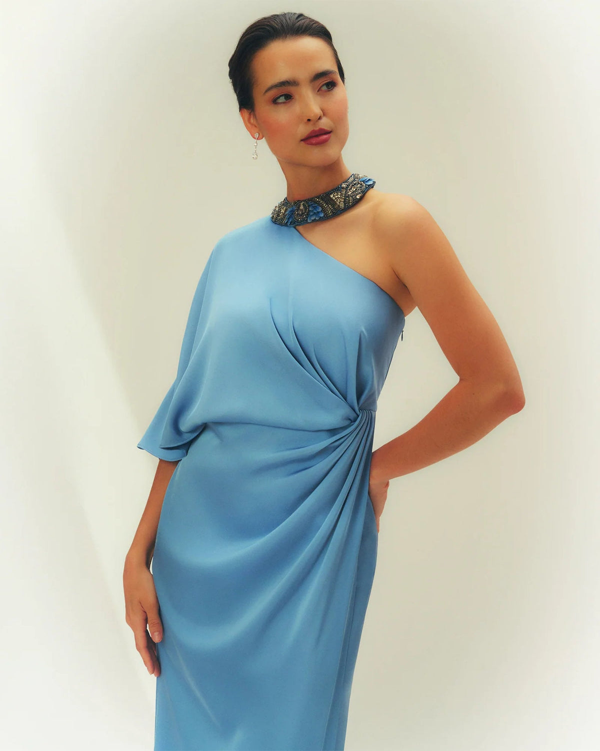 Light blue one-shoulder maxi dress with draped waist knot and jeweled collar