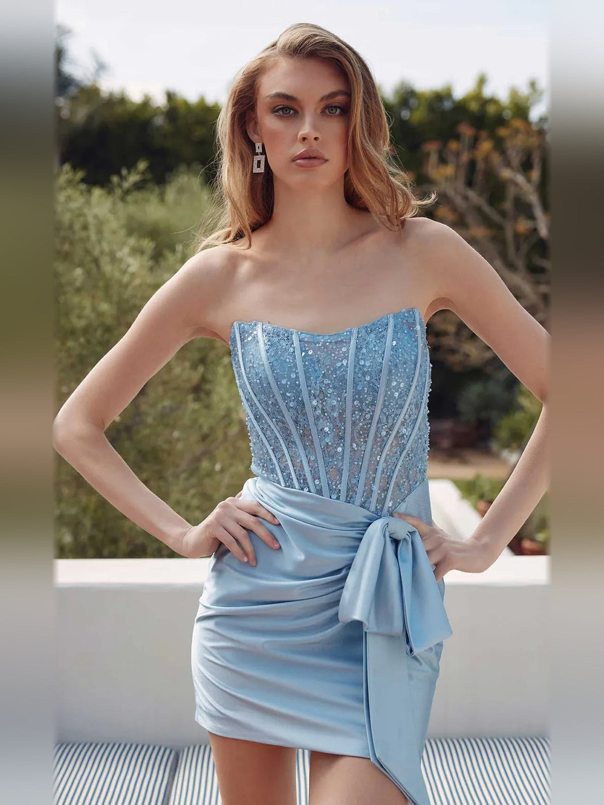 Light blue satin strapless mini dress with ruched drape and front bow detail