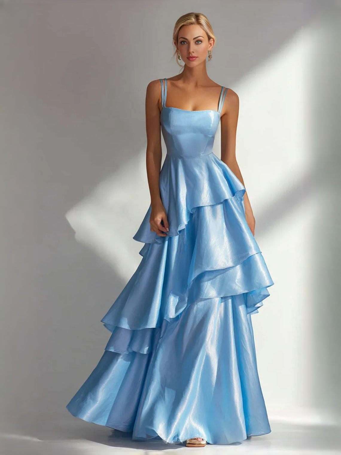 Light blue satin prom dress with square neckline, thin straps, and tiered ruffle A-line skirt.