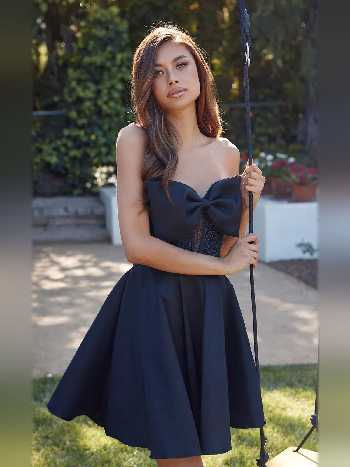 Strapless satin A-line mini dress with corset bodice and pleated skirt, dark blue, bow
