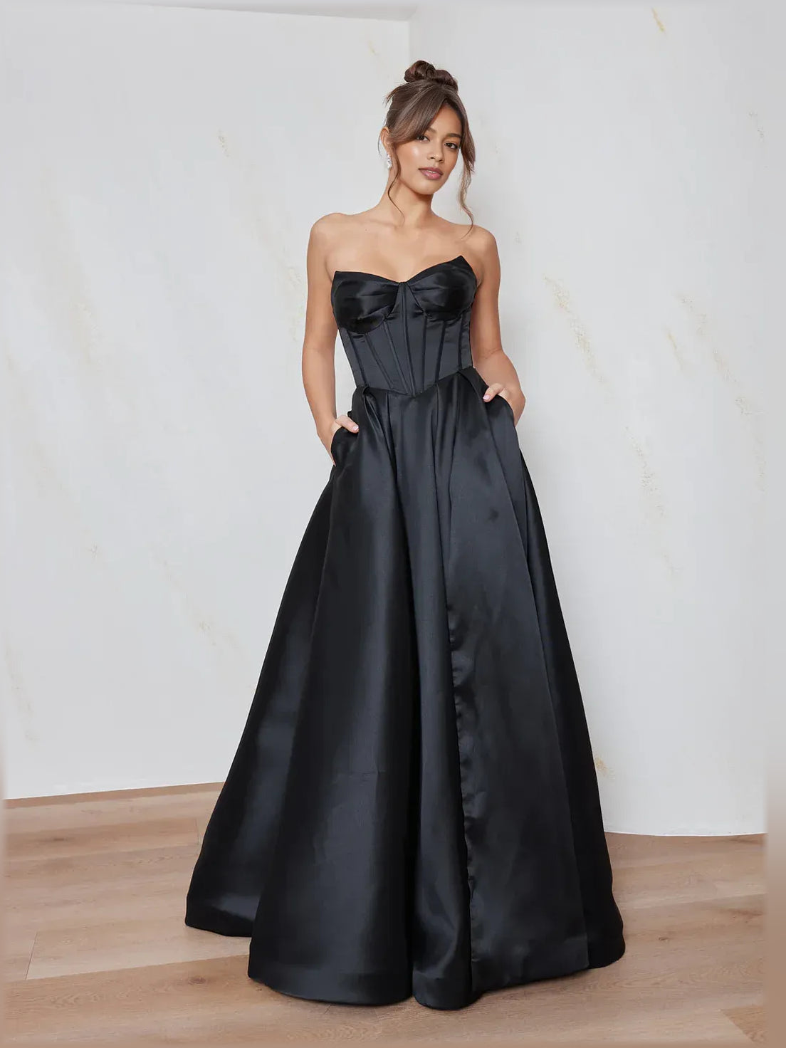 Black strapless sweetheart corset formal dress with gathered bodice and full floor skirt