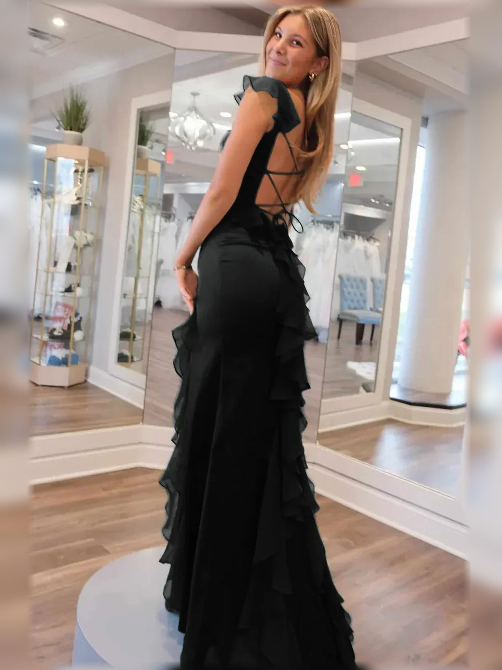 Black floor-length formal dress with square neck, ruffled sleeves, and lace-up back