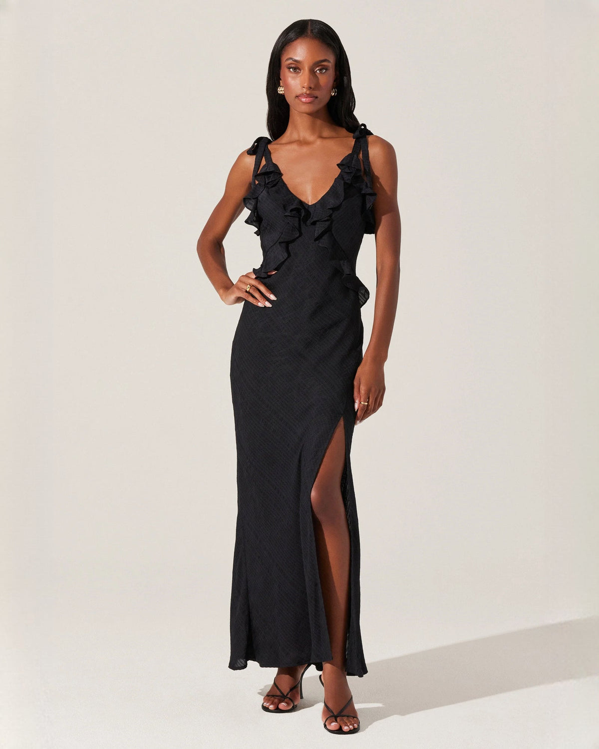 Black satin A-line maxi dress with sleeveless ruffle trim and front slit