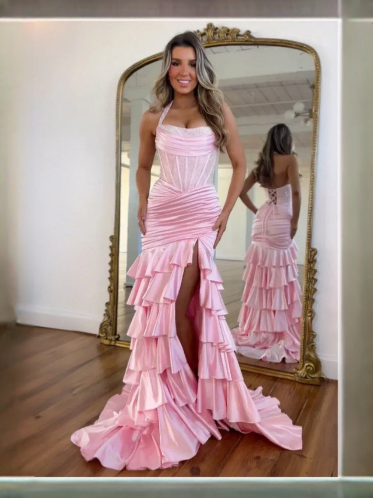 Blush pink halter mermaid prom dress with ruched corset bodice and tiered ruffles