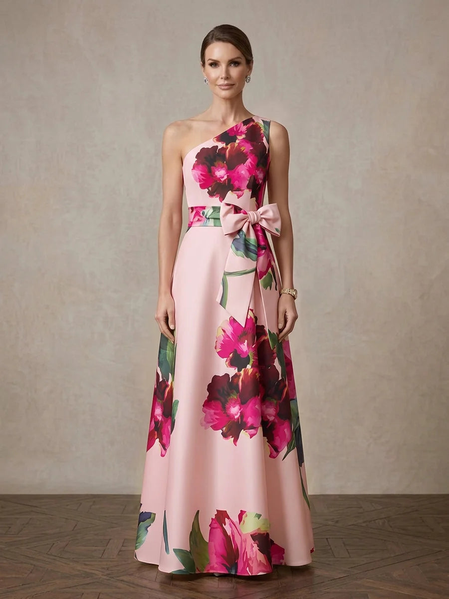 Front one-shoulder light pink floral A-line satin gown with tied bow at waist.