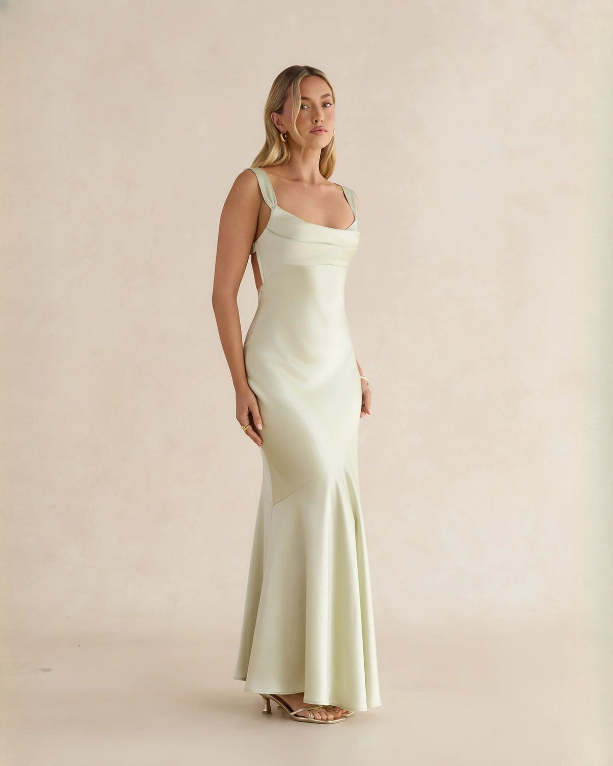 Sleeveless satin A-line maxi dress in pale yellow, angled front view