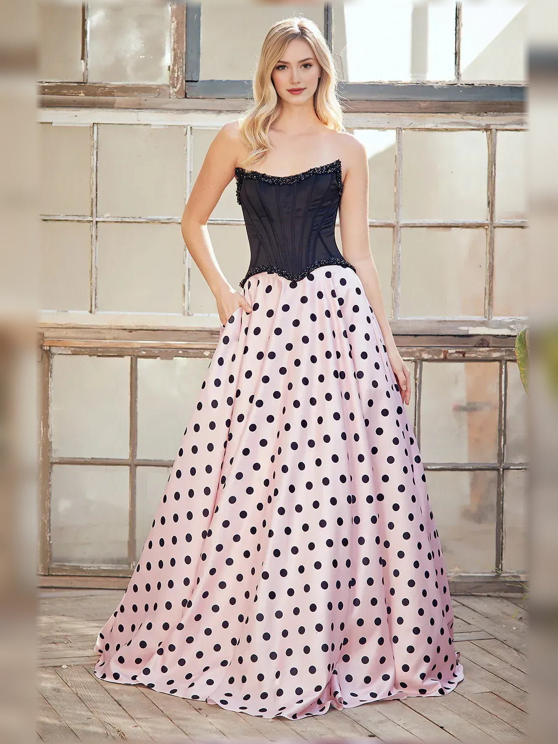 Sweetheart corset formal dress with black bodice and blush pink polka-dot full skirt