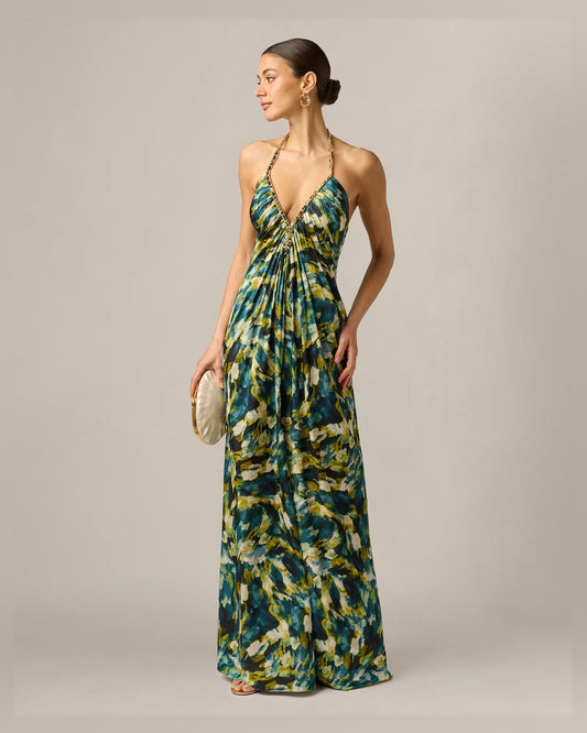 Front view of green halter neck A-line formal dress with beaded straps and flowing skirt.
