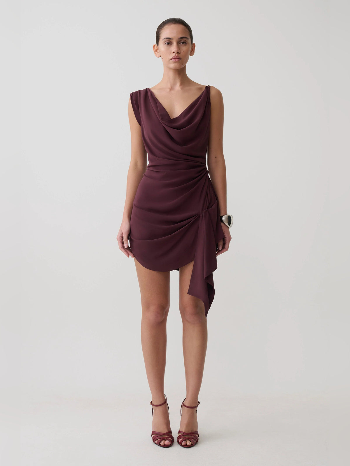 Plum satin mini homecoming dress with draped cowl neck and asymmetrical side drape
