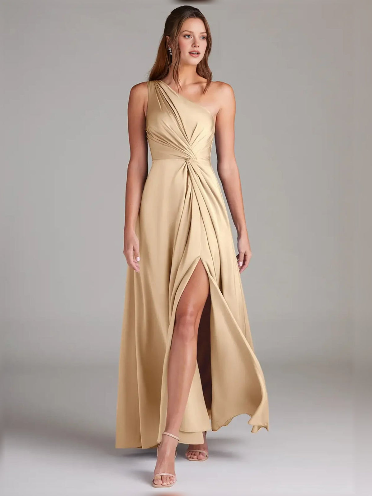 Champagne gold one-shoulder formal dress with twisted bodice and thigh slit, A-line.