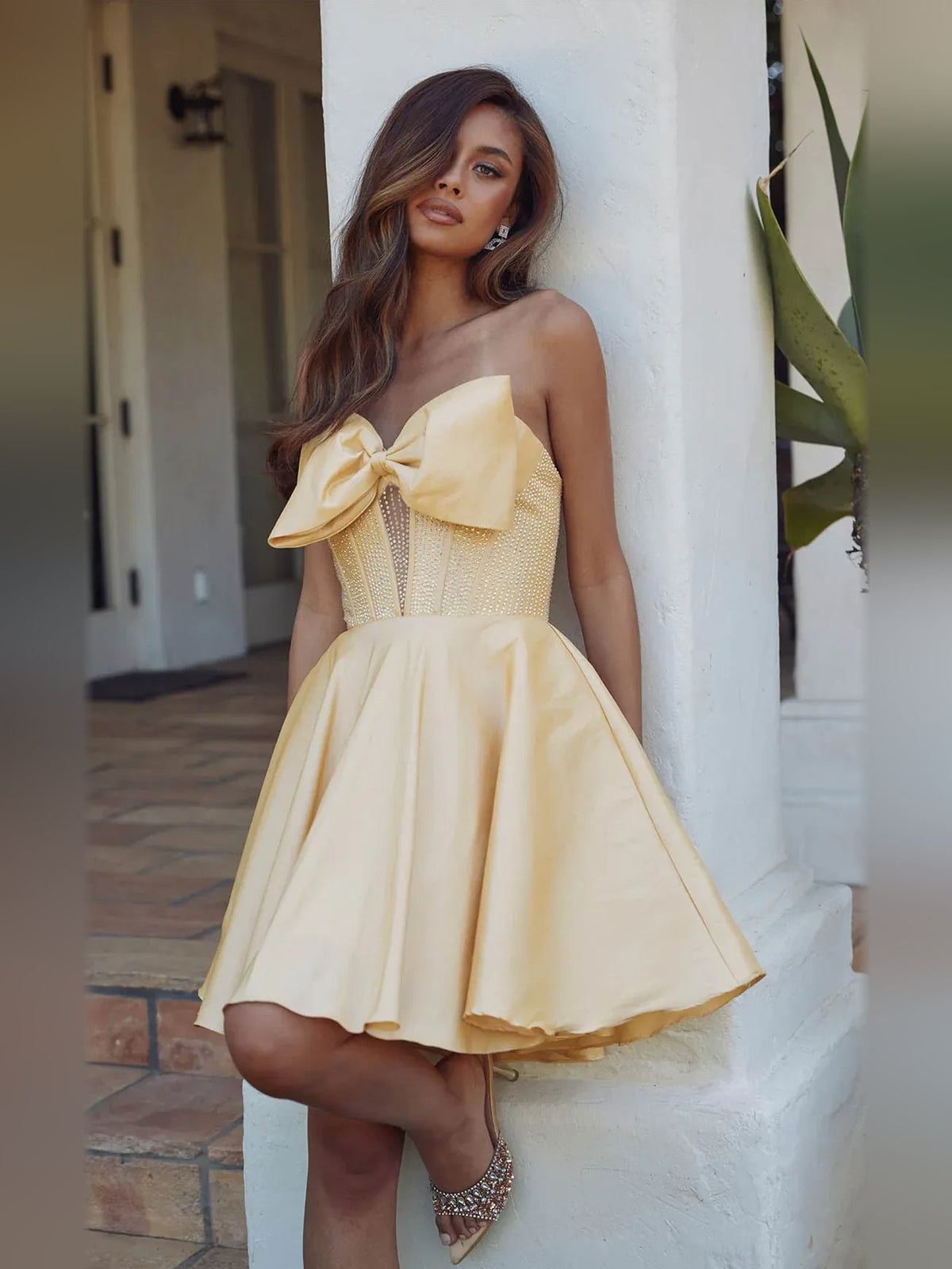 Strapless satin A-line mini dress with corset bodice and pleated skirt, pale yellow, bow
