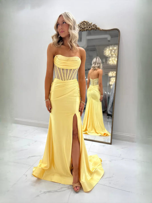 Yellow strapless satin prom dress with corset-style bodice, ruched details, and slit