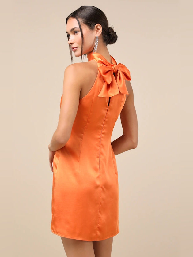 Orange satin halter mini dress with scooped back and tied bow