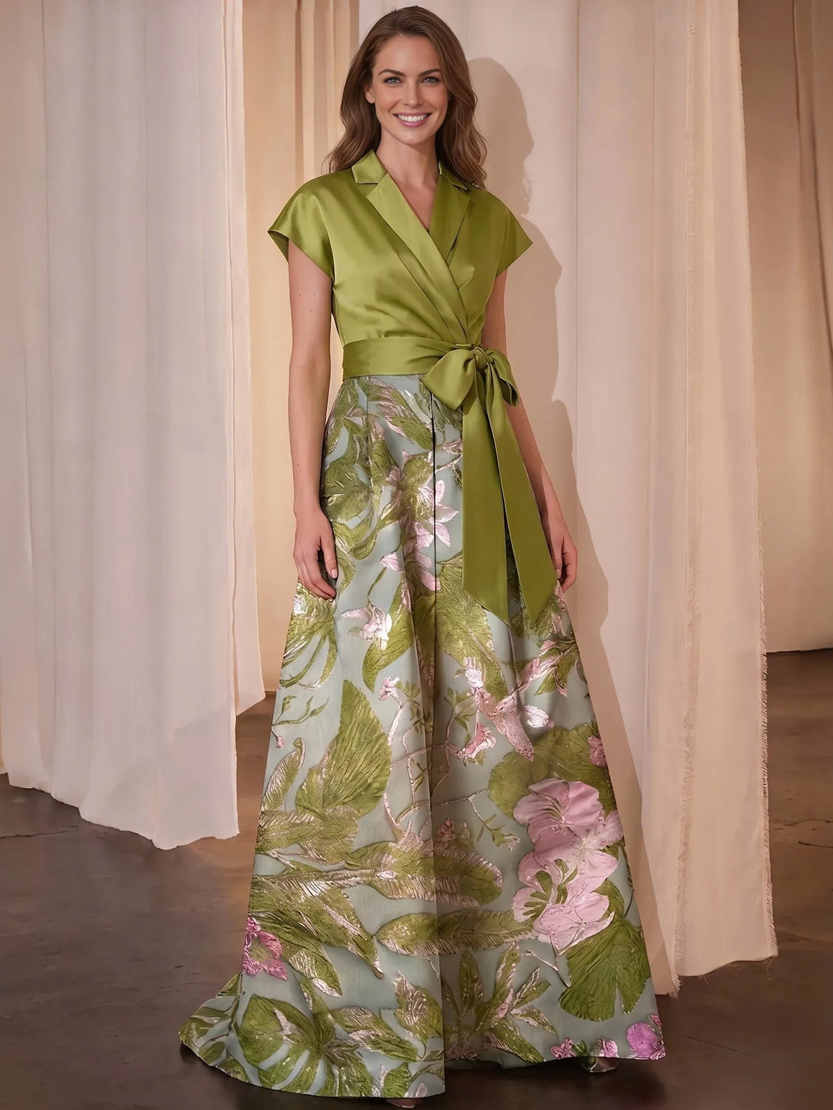 Front view: green satin V-neck A-line dress with floral skirt and tied waist