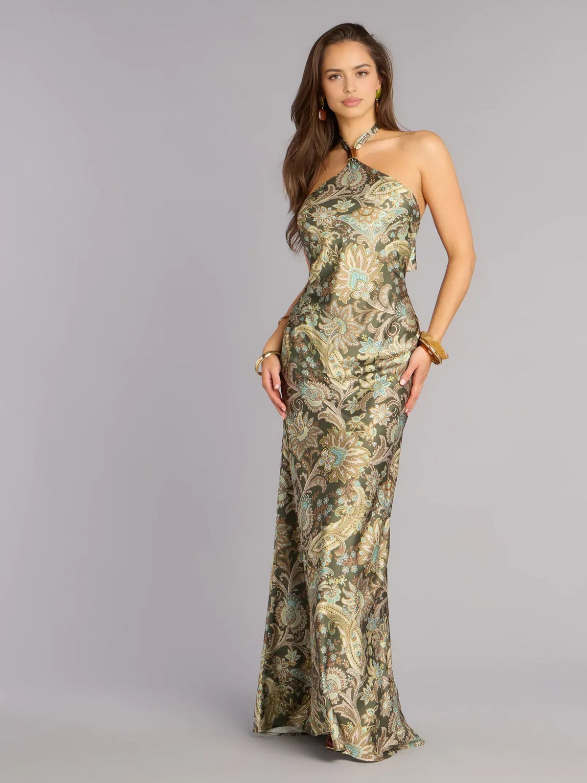 Printed halter-neck open-back maxi dress, full front view in olive and teal paisley