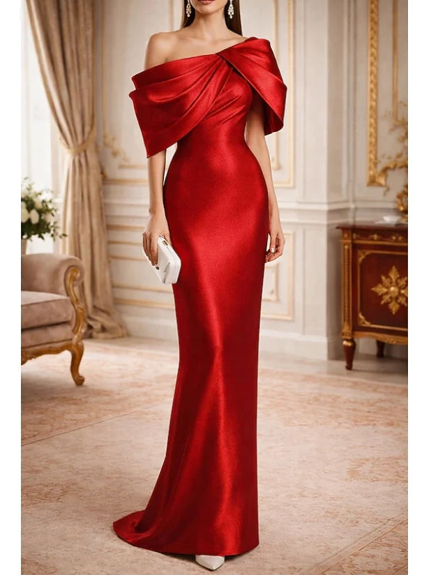 Red one-shoulder satin gown with sculpted drape across the shoulder, floor-length.