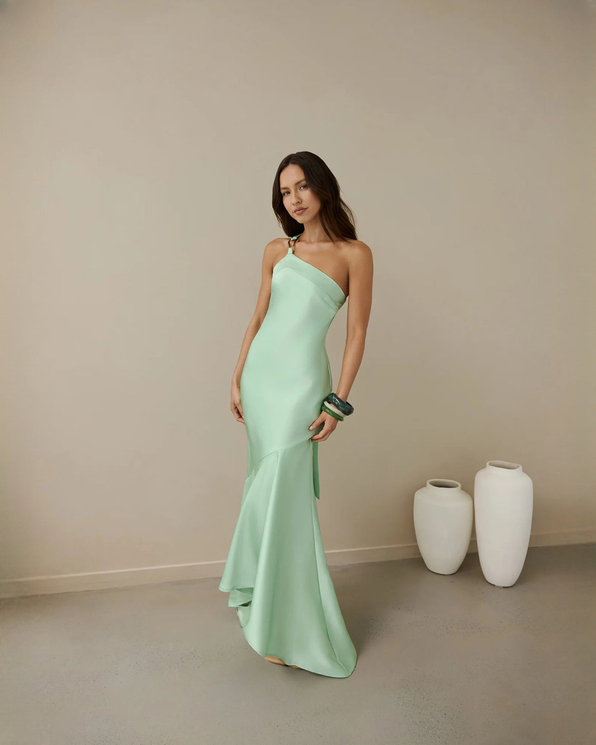 One-shoulder satin maxi bridesmaid dress in emerald green, fitted silhouette with side drape hem