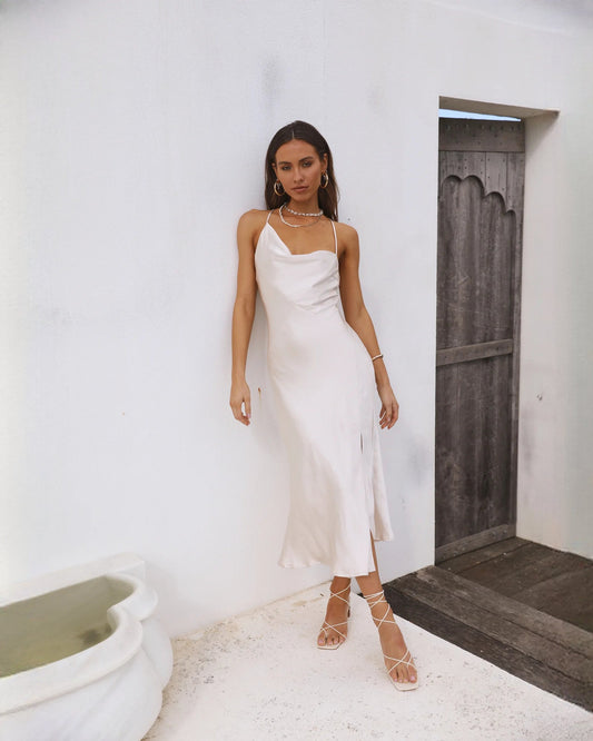 White satin sleeveless A-line maxi dress with side slit and delicate spaghetti straps