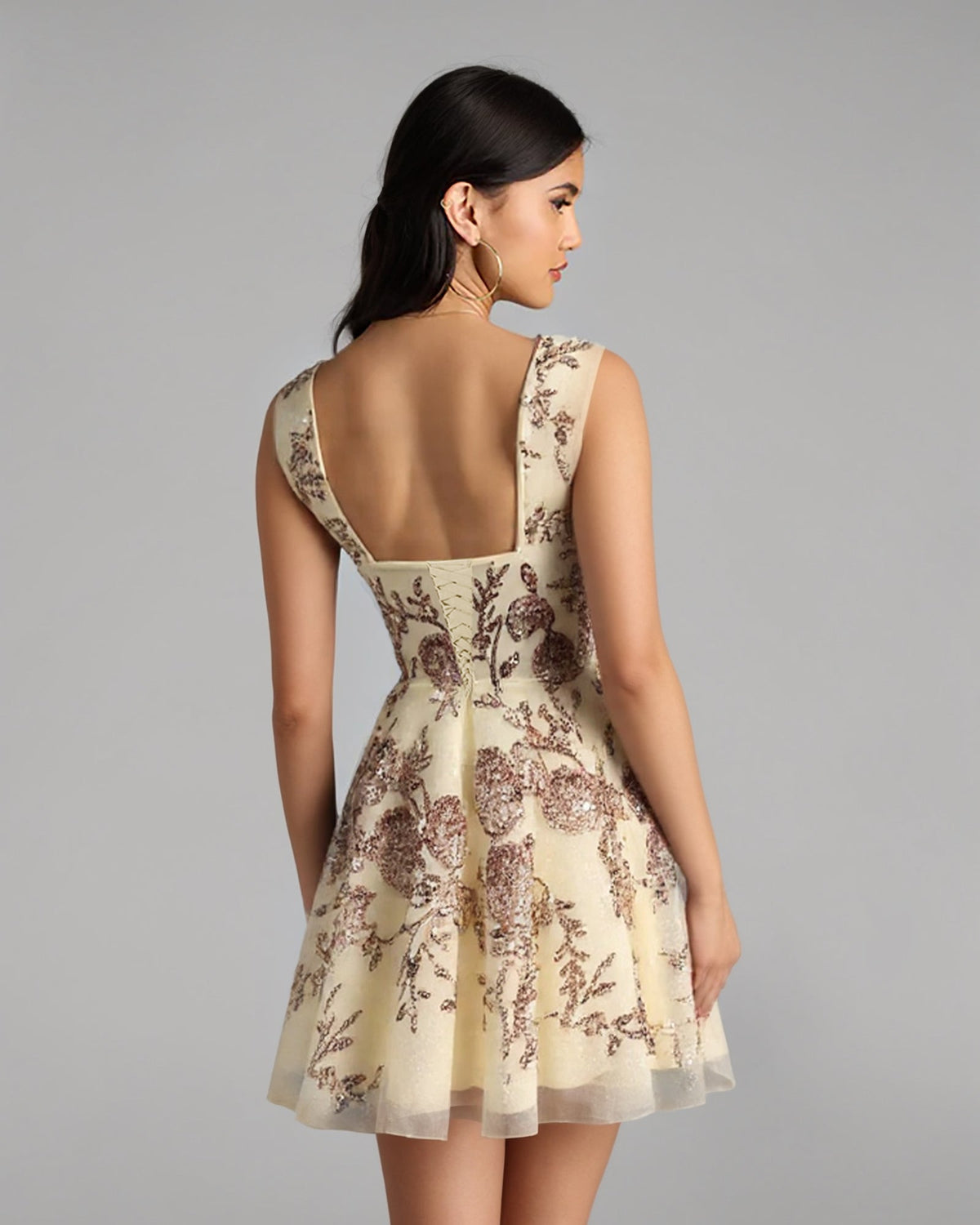 Beige floral corset cocktail dress with open-back detail and short flared skirt