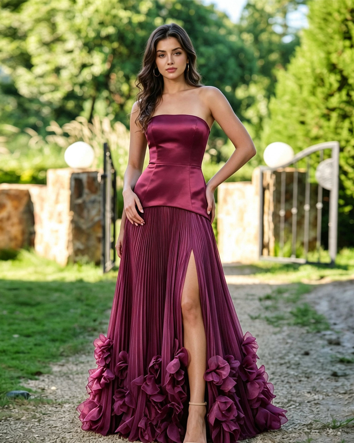 Strapless formal dress in plum satin, pleated slit skirt with floral ruffle hem