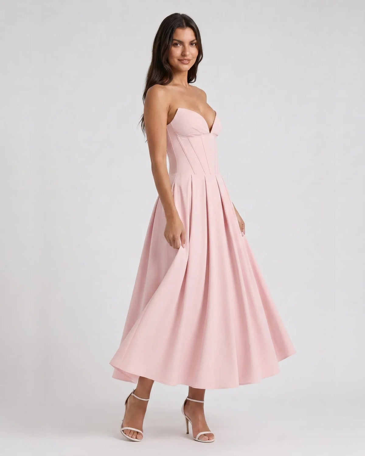 Blush pink strapless sweetheart corset midi dress with pleated A-line skirt